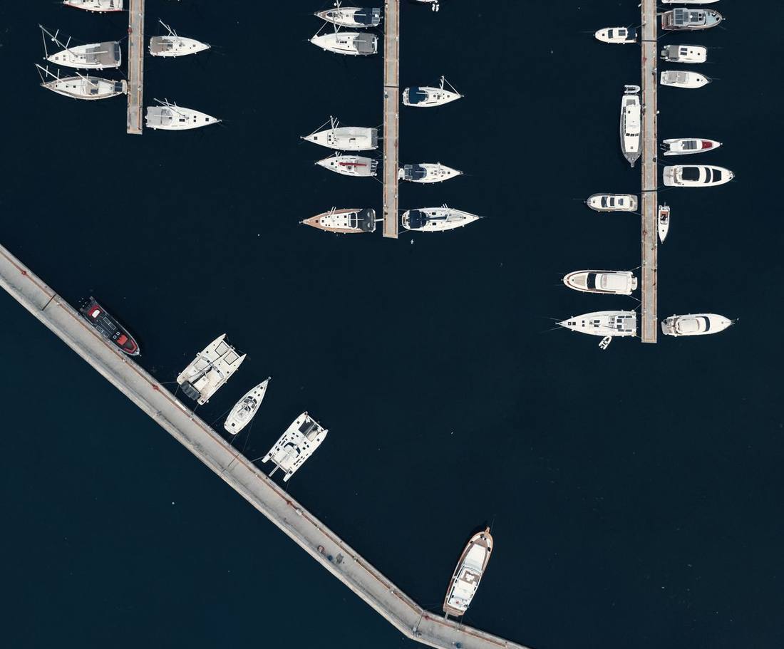 Aerial view of yachts moored in ordered rows in a marina