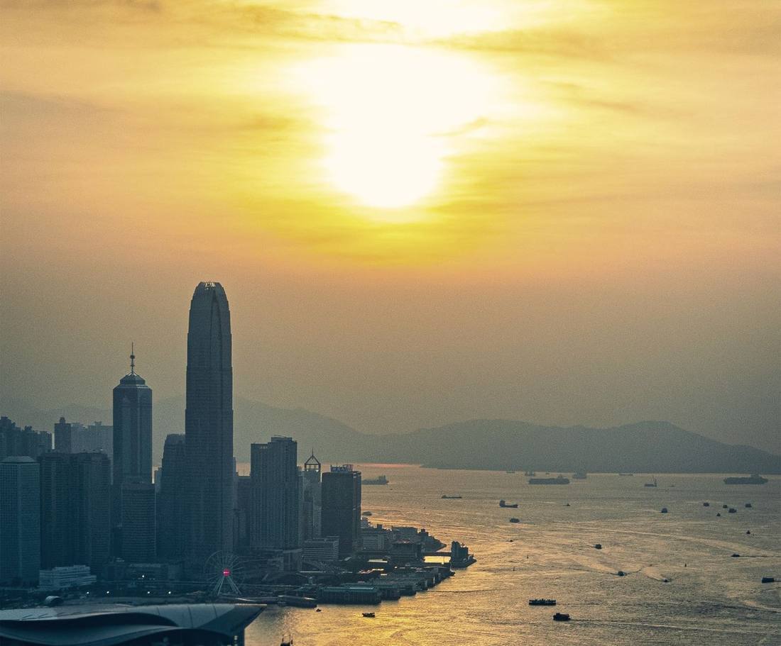 A financial harbour at sunset with shipping on the water